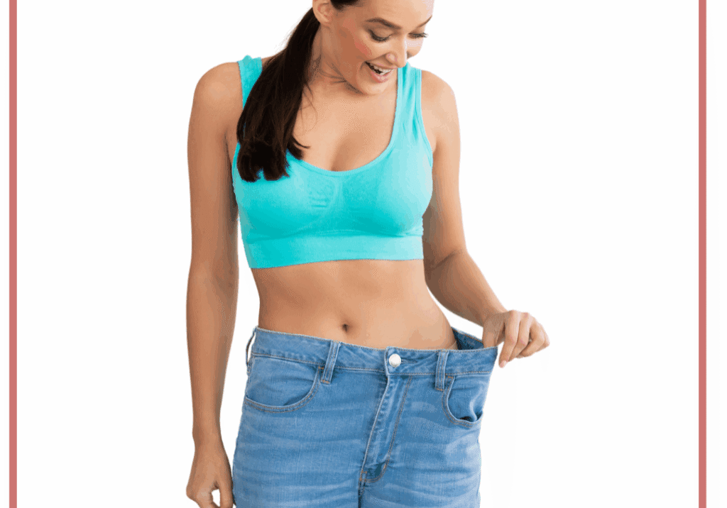 Woman holding loose jeans showing slimmer waist